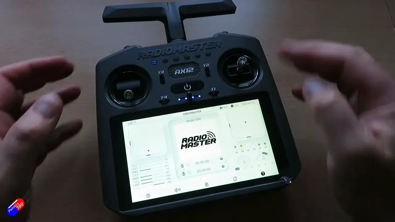 RadioMaster AX12 front view showing the touchscreen, gimbals and fewer physical controls with hands in motion