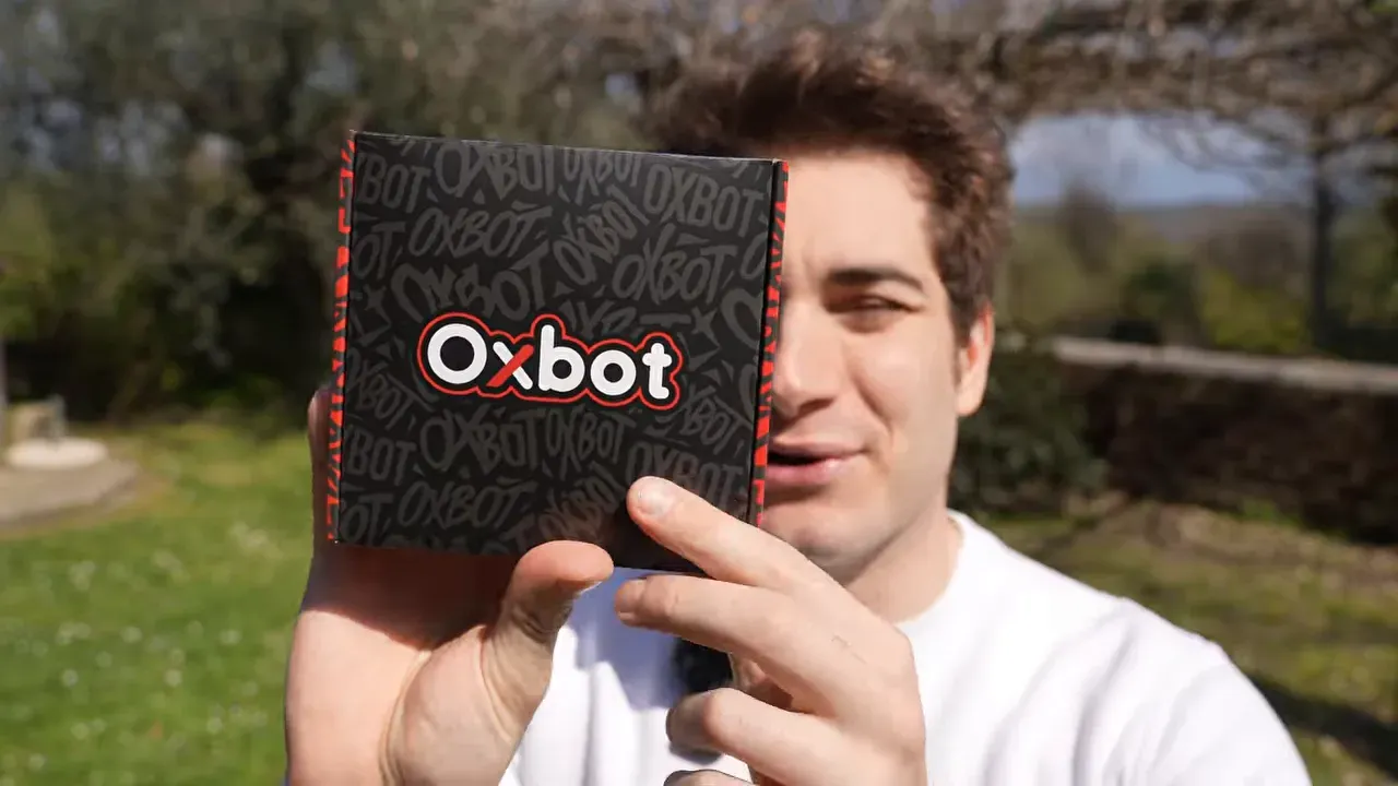 Oxbot Lumo18 box held in hand outdoors