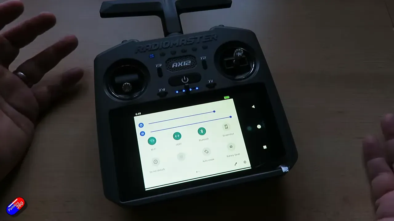 RadioMaster AX12 handheld radio showing the Android quick settings on the touchscreen, full device visible
