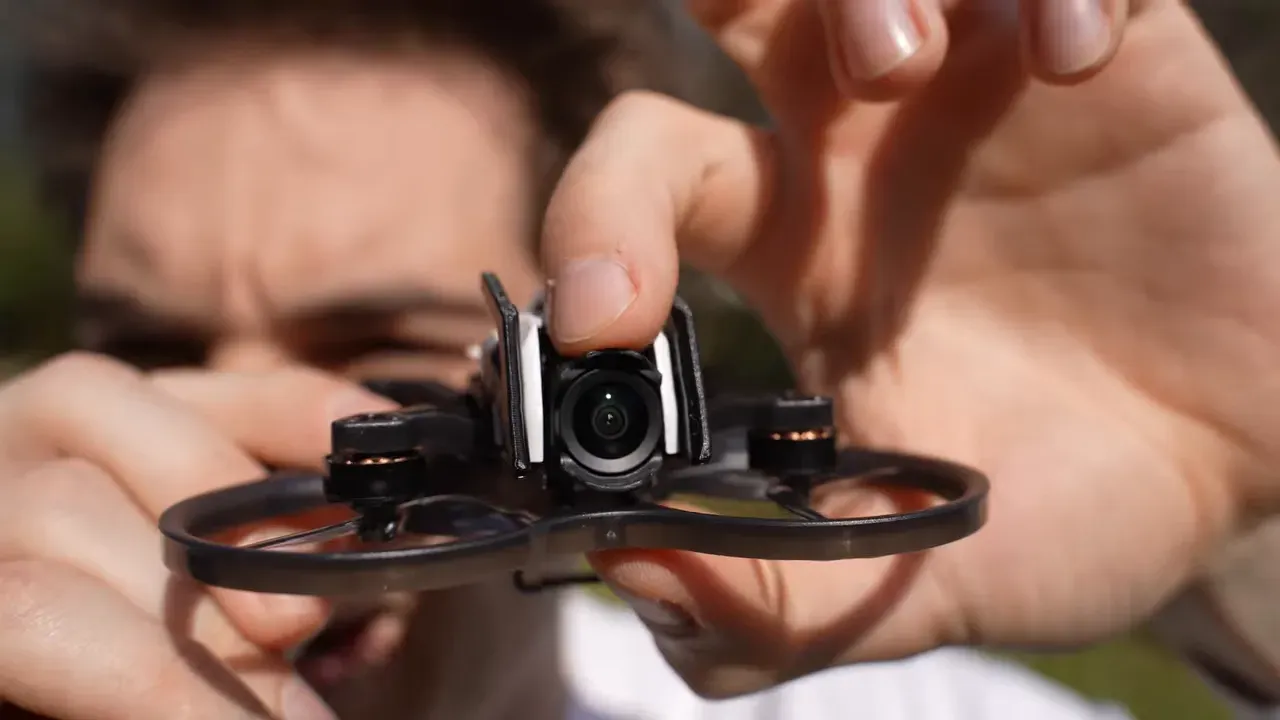 Oxbot Lumo18 in-hand close-up showing the DJI O4 Lite camera mount