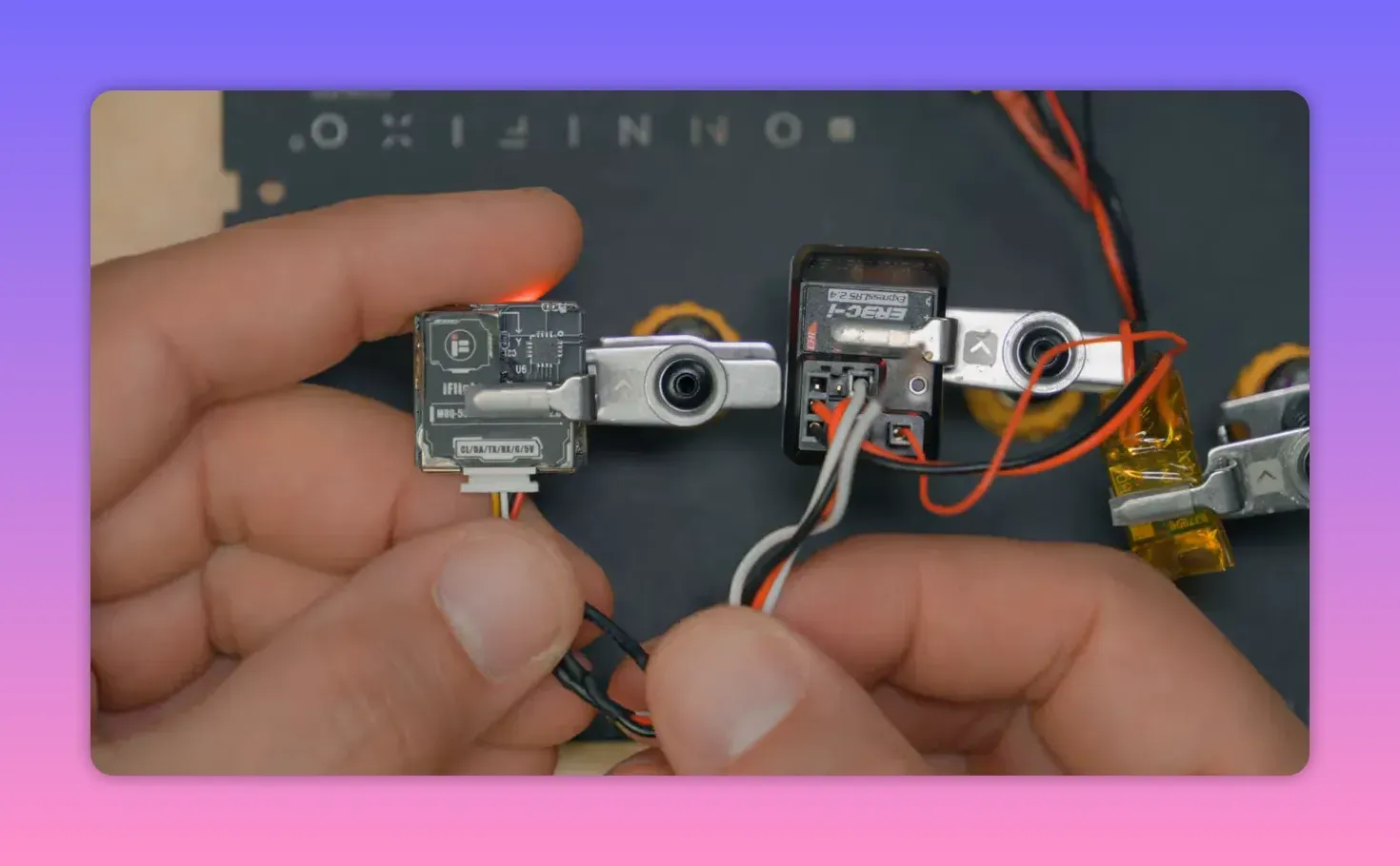 Close-up of ELRS receiver wiring showing GPS connections for Serial RX