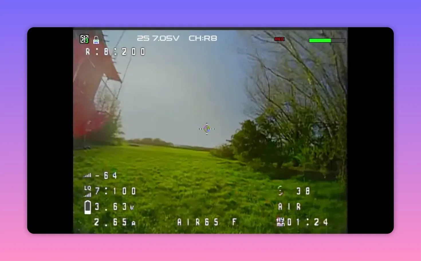 Analogue FPV HUD view on CH R8 with REC overlay flying over green grass