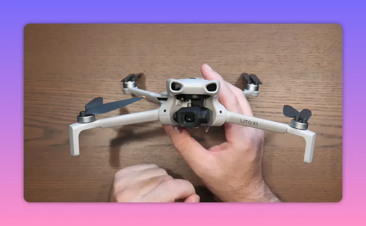 Close-up of the DJI Lito X1 camera module and gimbal on a wooden surface