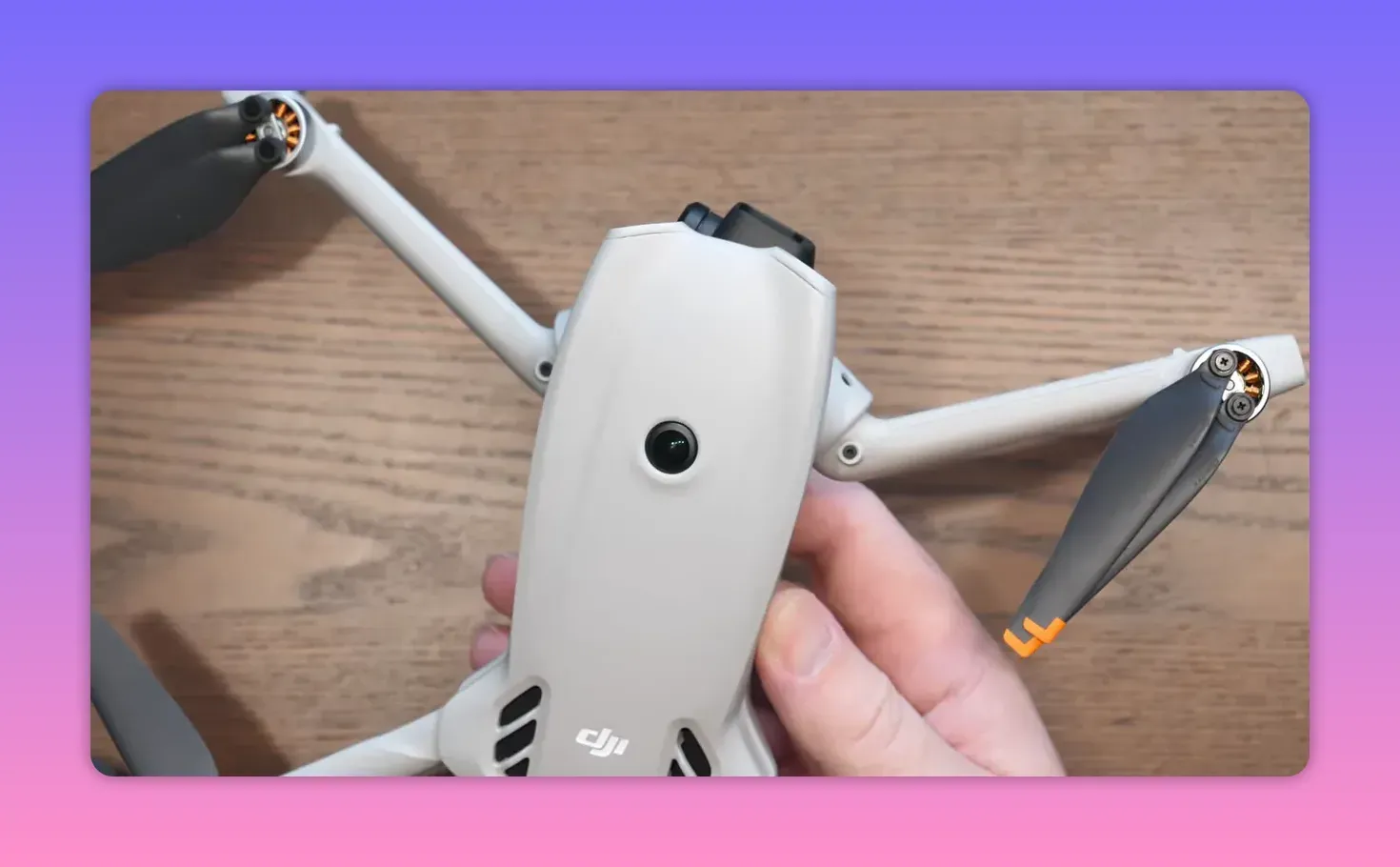 Close-up of the folded DJI Lito X1 front sensing lens module held by hands