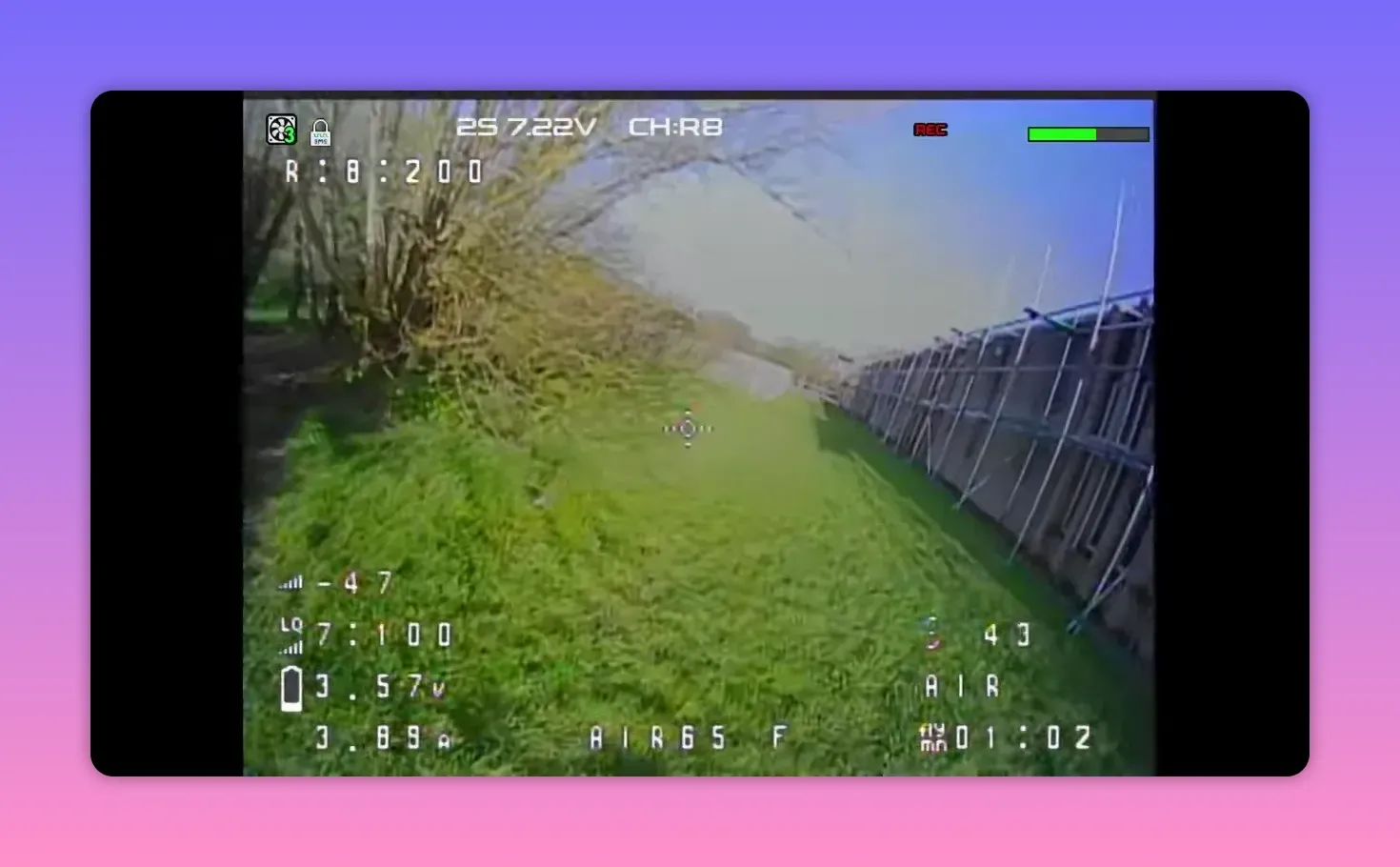 Analogue FPV HUD feed during BetaFPV Air65 II flight on CH: R8 along a fence line with REC overlay