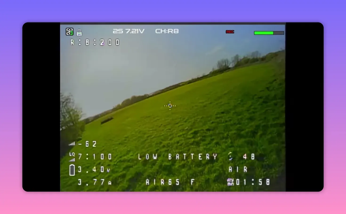 Analogue FPV HUD view on CH R8 over grass with REC status during BetaFPV Air65 II flight