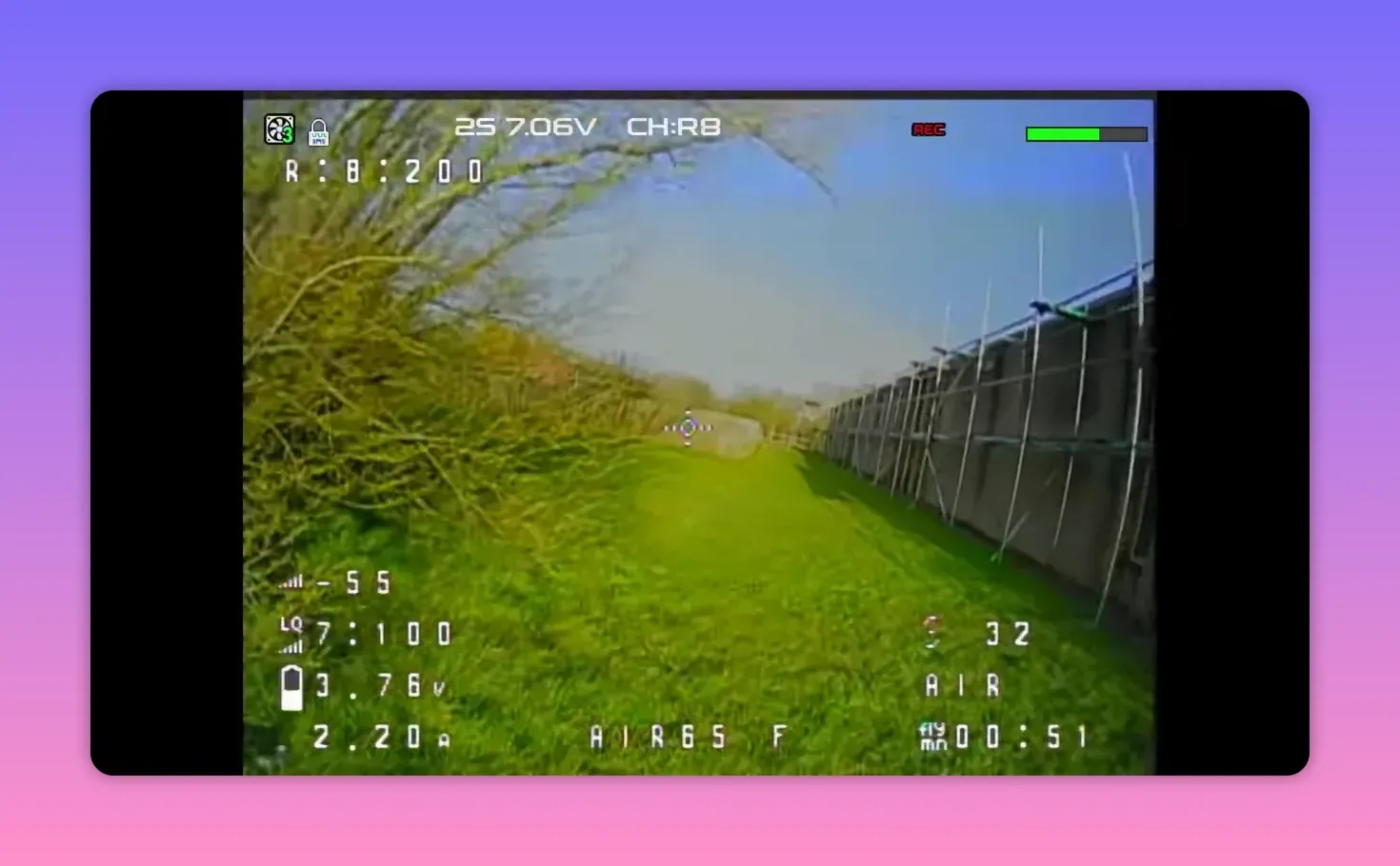 Analogue FPV HUD feed from the BetaFPV Air65 II on CH: R8 with REC status and telemetry flying along a fenced grass path
