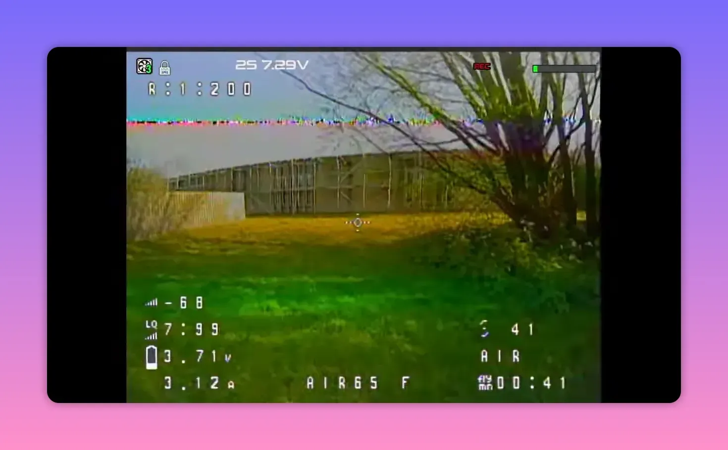 Analogue FPV HUD view of BetaFPV Air65 II freestyle flying over grass near trees (R1 channel)