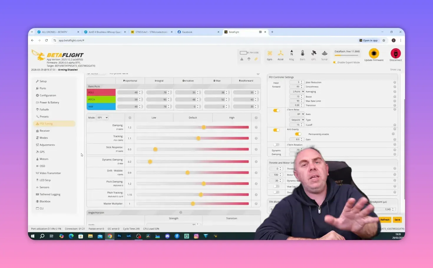 Betaflight tuning sliders and PID controller settings for the BetaFPV Air65 II shown on screen with reviewer in frame