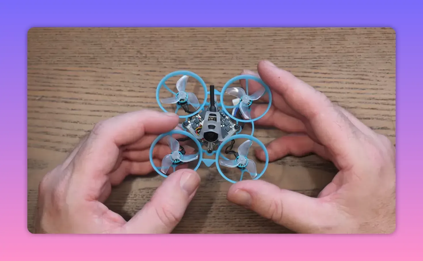 BetaFPV Air65 II freestyle whoop held in hands on a wooden table during weight testing