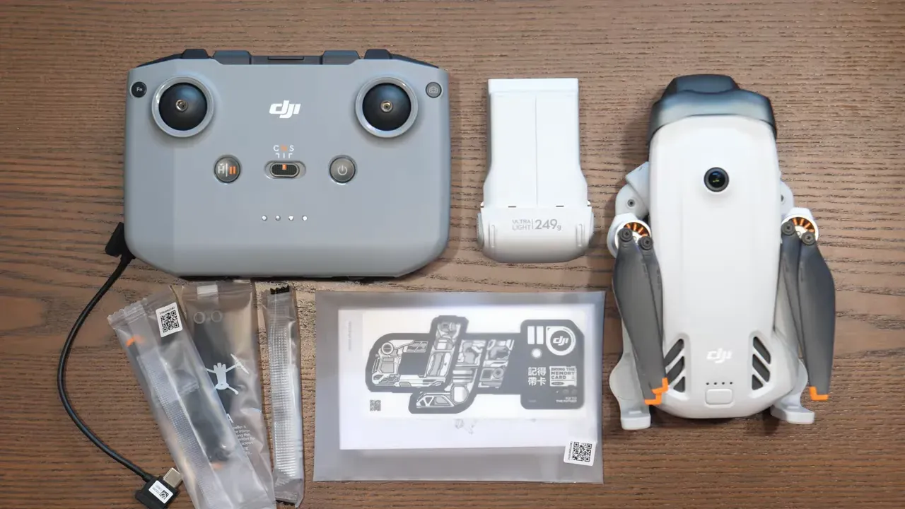 Reviewer pointing while comparing DJI Lito 1 and DJI Lito X1 boxes