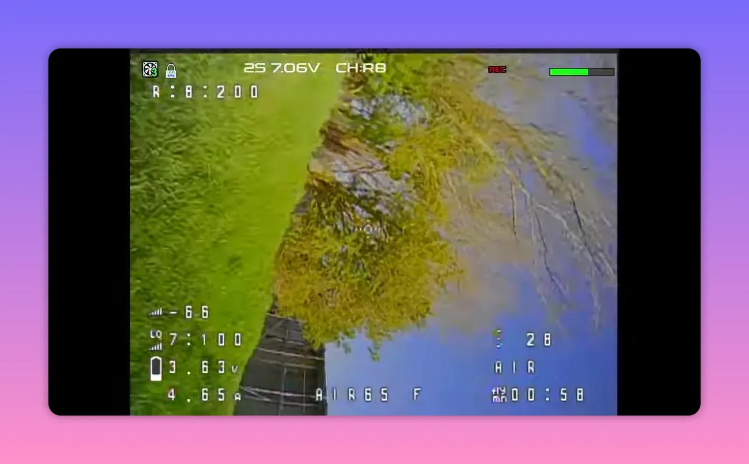 Analogue FPV HUD view from the BetaFPV Air65 II on CH R8 with REC overlay during flight near a fence line