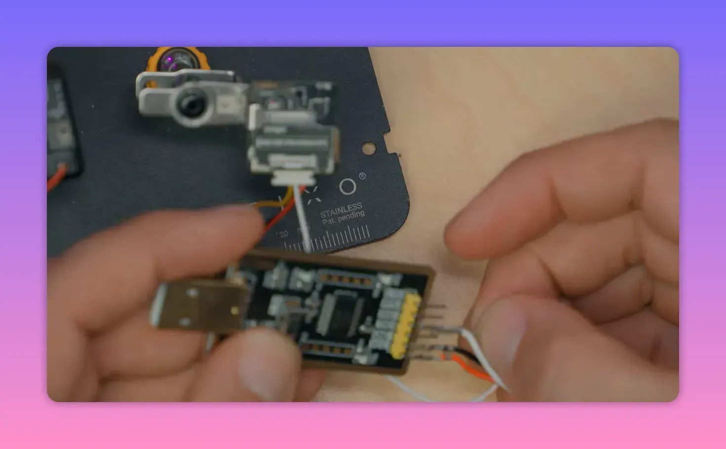 Close-up of an ExpressLRS receiver being wired with GPS connections