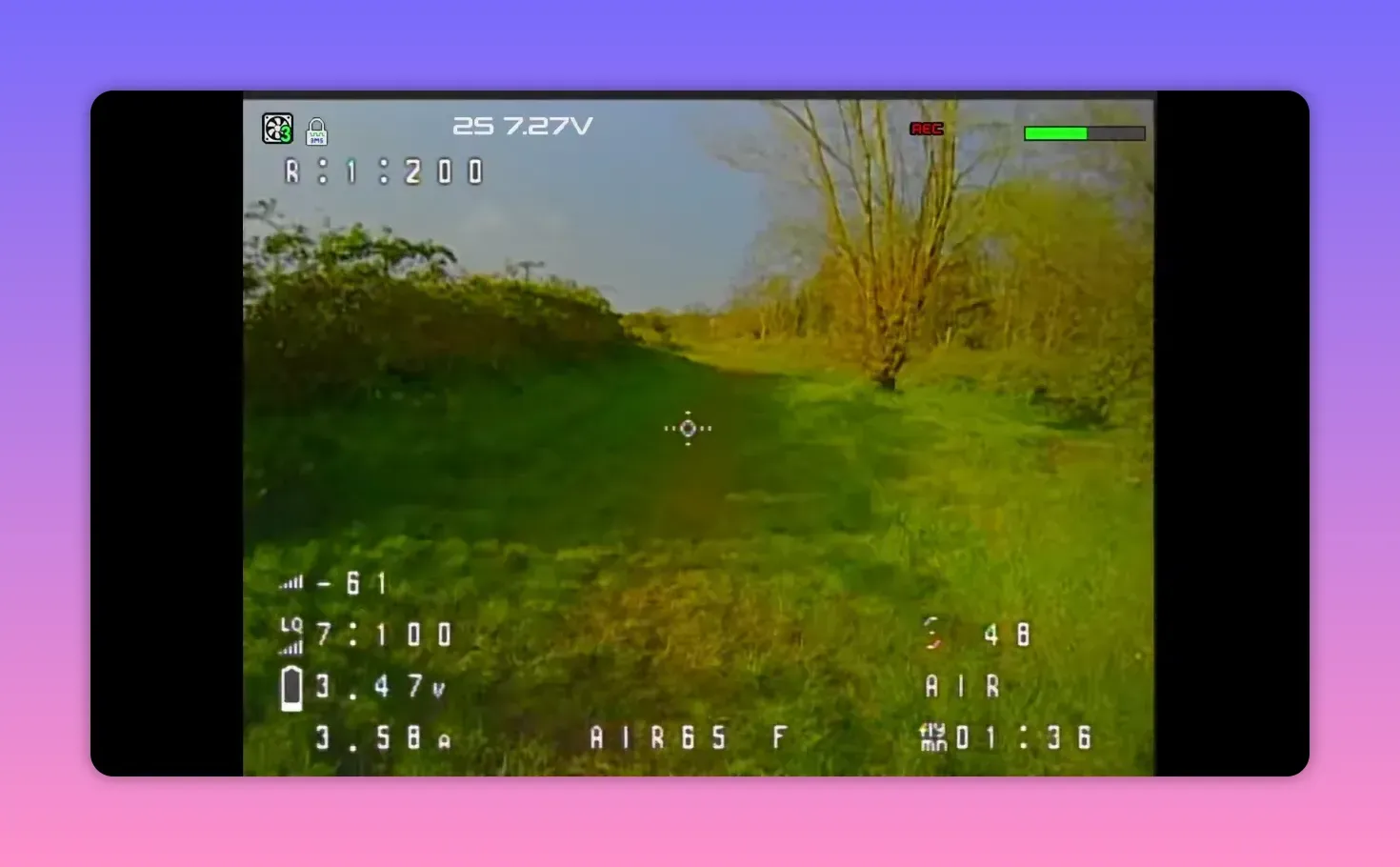 Analogue FPV HUD view showing CH R1 reception breakup during BetaFPV Air65 II flight over grass