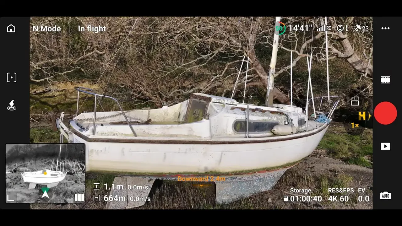 DJI Lito 1 Fly app obstacle sensing view over a wooded shoreline with flight telemetry