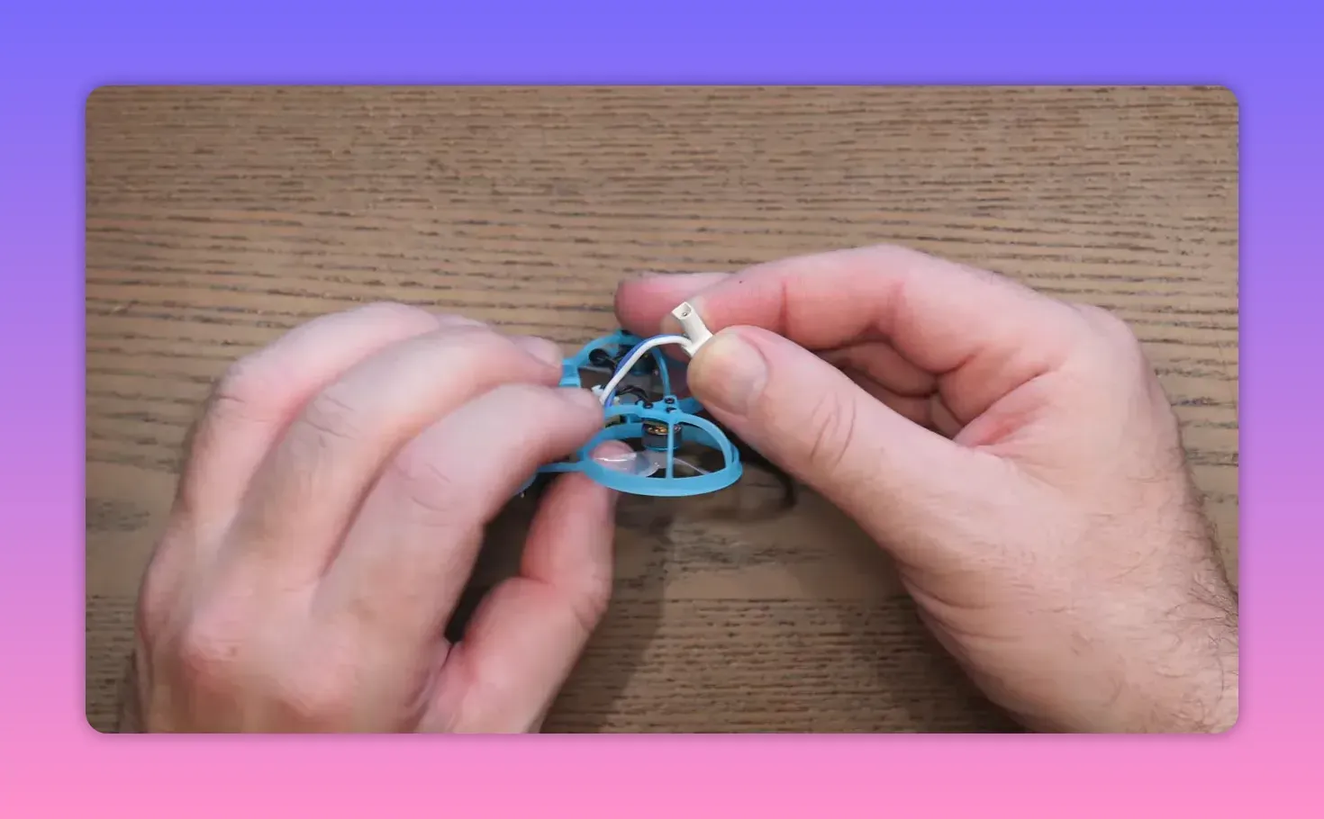 Hands installing or connecting a small connector on the BetaFPV Air65 II