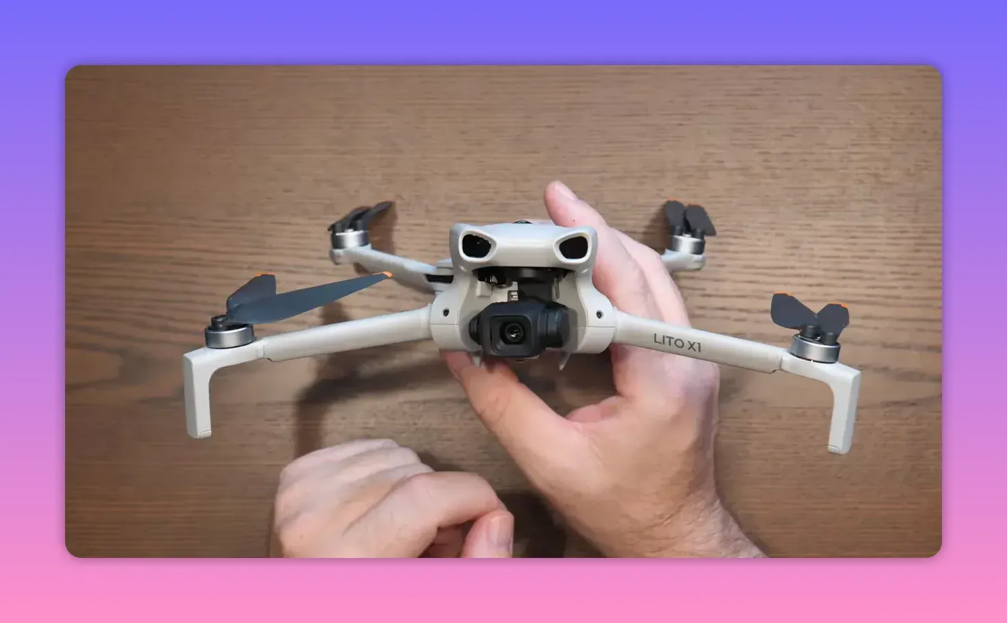 Presenter holding a DJI Lito X1 drone next to the DJI Lito X1 Fly More packaging box in a studio