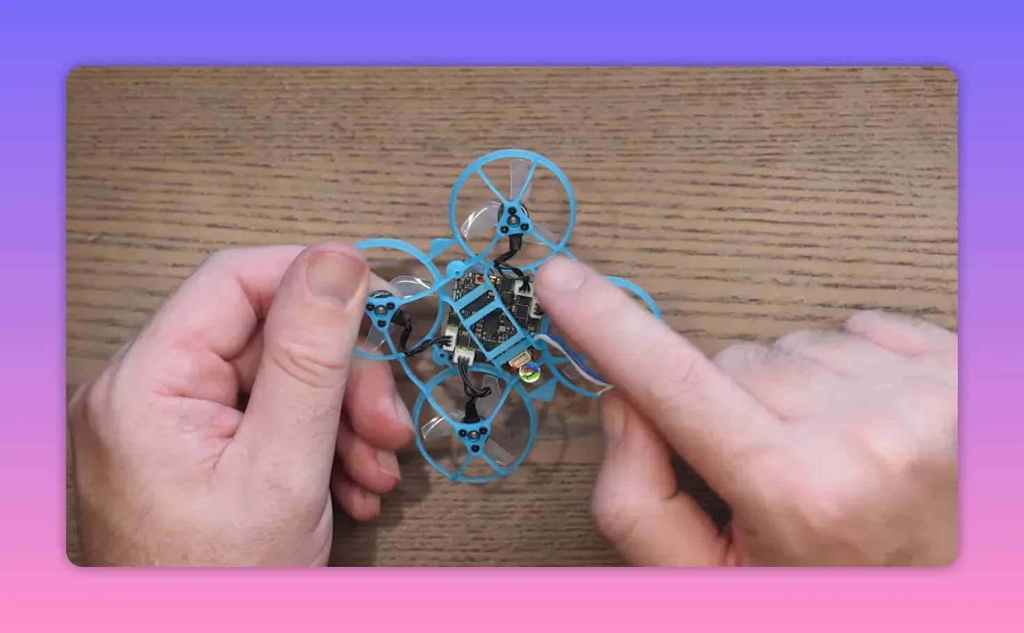 Front view of the BetaFPV Air65 II whoop in hands showing frame, motors, and electronics