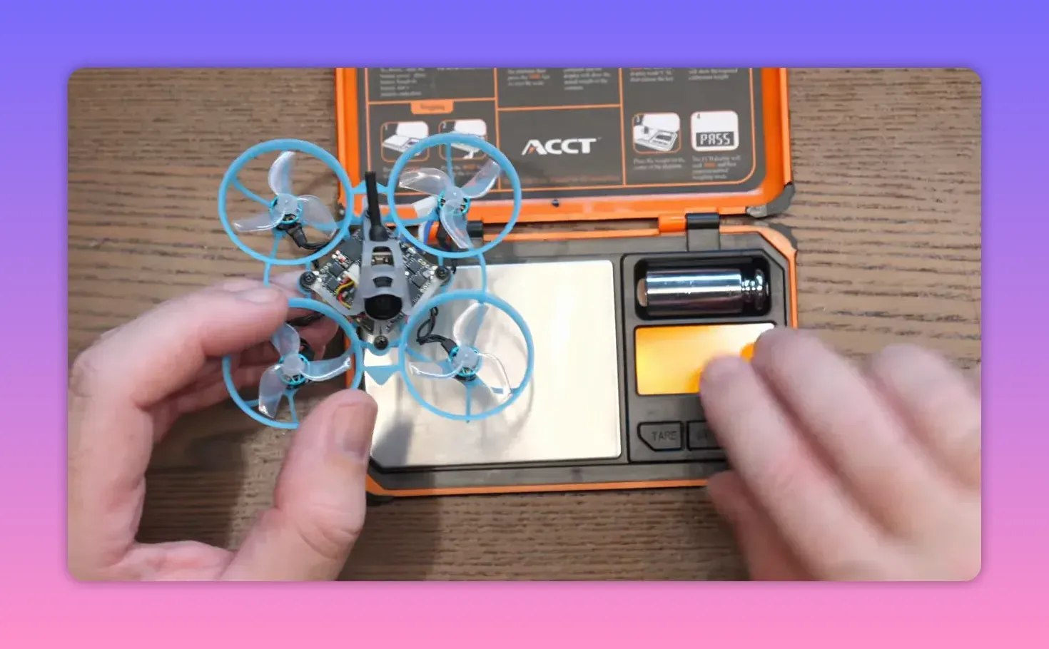 Top-down view of the BetaFPV Air65 II freestyle whoop in hands on top of the packaging box