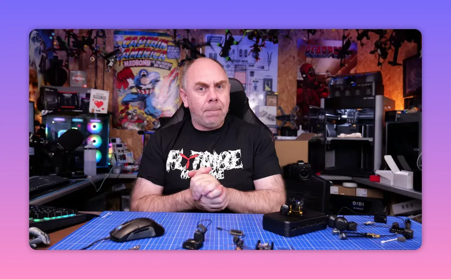Presenter seated at an FPV workbench explaining the DJI O4 Pro gyro issue with parts on the table