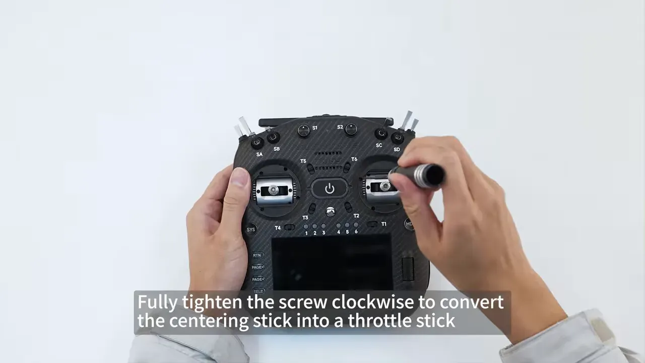 Hex wrench tightening the right stick gimbal screw on the front of a TX16S MK3