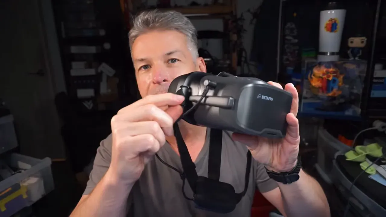 Side view of the goggles showing folded antenna and barrel power lead connection