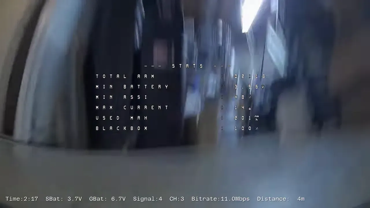 FPV view stopped low on the floor in a utility room with shelving and equipment