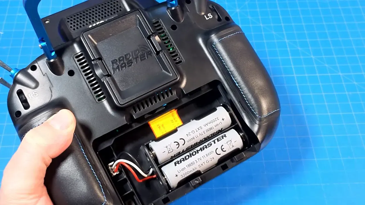 Open rear battery bay of RadioMaster GX15 holding two 18650 cells