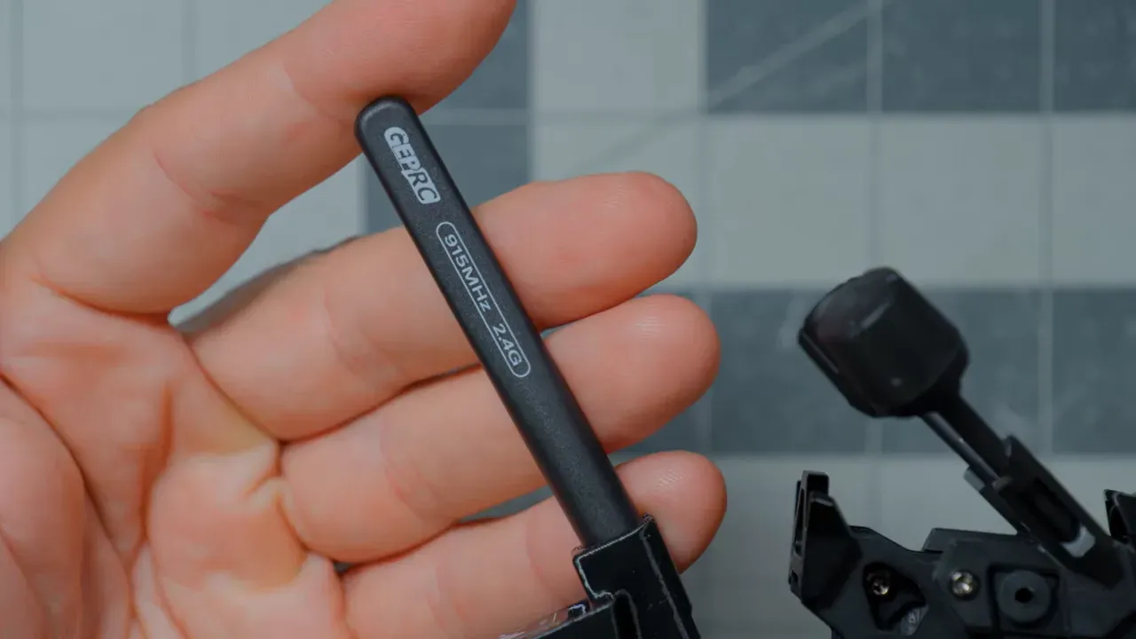Close-up of the dual-band receiver antenna held beside the drone