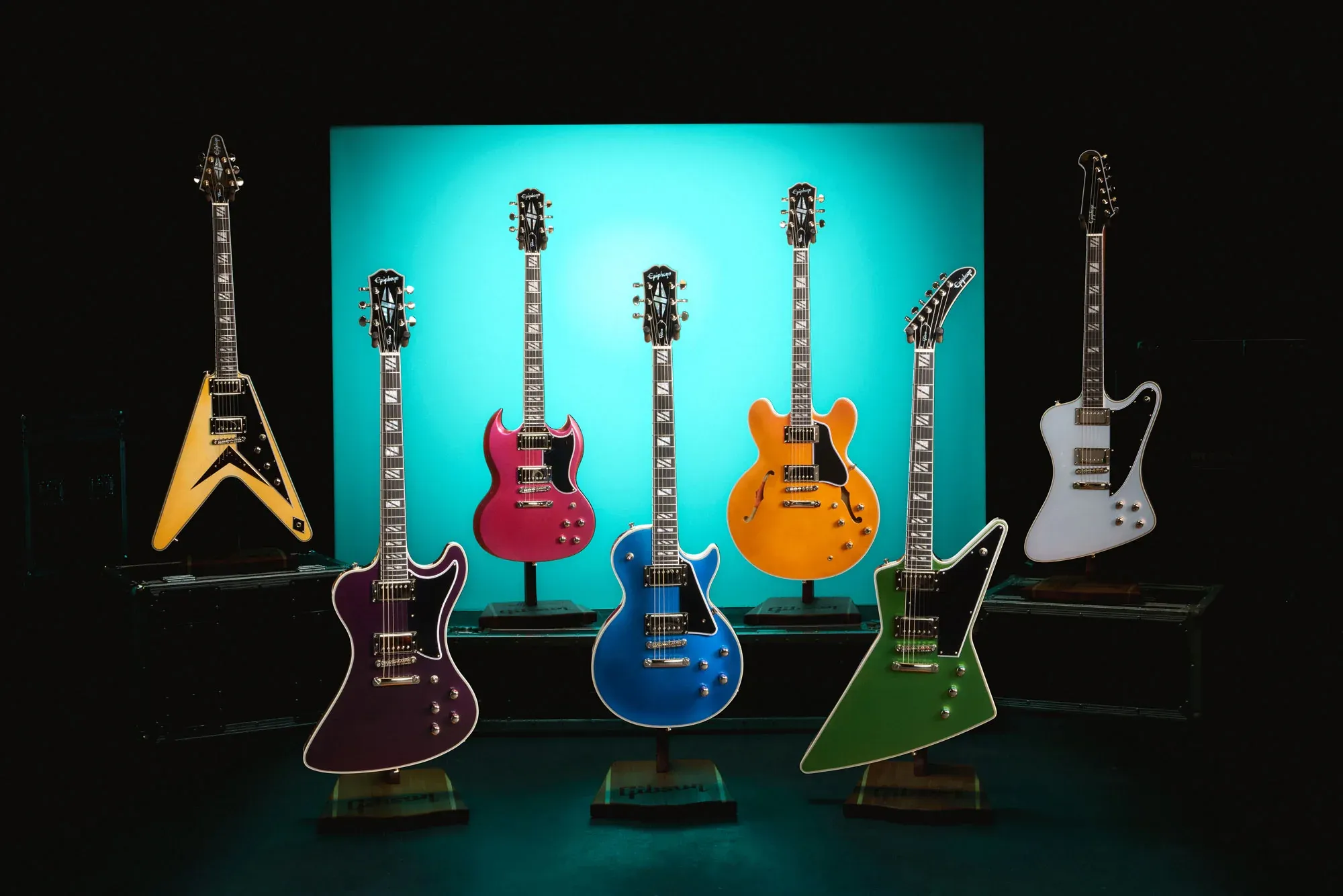 L-R: Epiphone Futura Flying V Custom, RD Custom, SG Custom, Les Paul Custom, ES-355 Custom, Explorer Custom & Firebird Custom. Image c/o Gibson Guitars